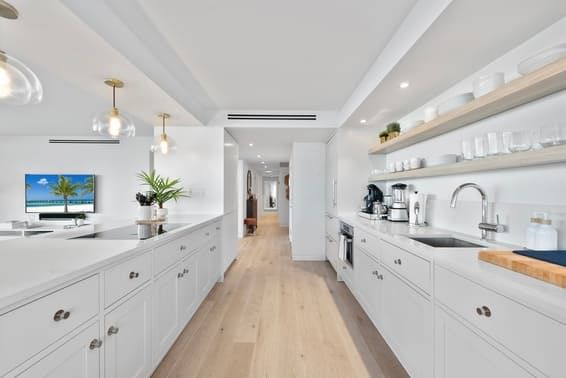 A large, bright, white kitchen in a Florida home.