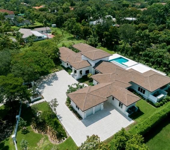 Luxury home in Florida with pool in the backyard and trees surrounding home